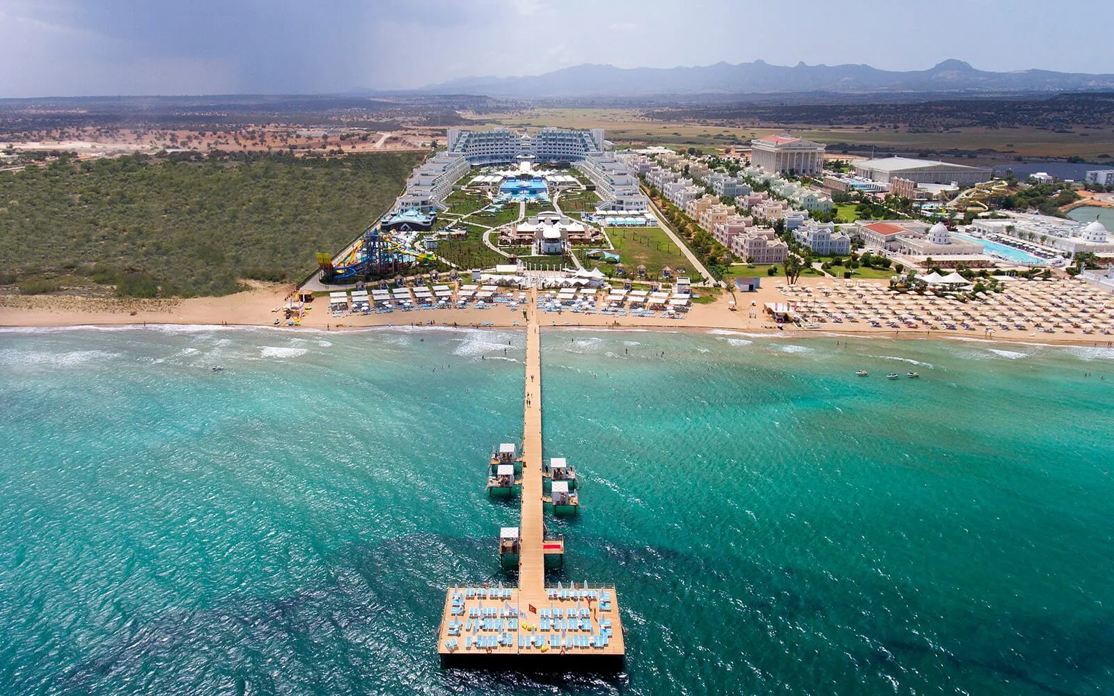 Chauffeur waiting with luggage at Limak Cyprus Deluxe Hotel drop-off point