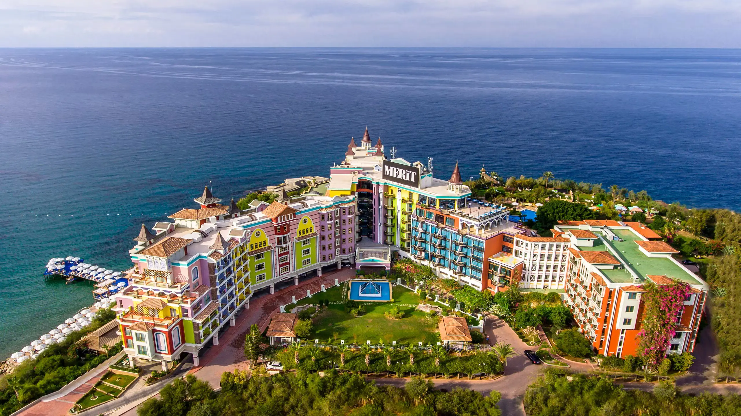 Private luxury taxi arriving at Merit Crystal Cove Hotel, a 5-star beachfront resort in Kyrenia, North Cyprus, featuring a private marina and crystal-clear pool