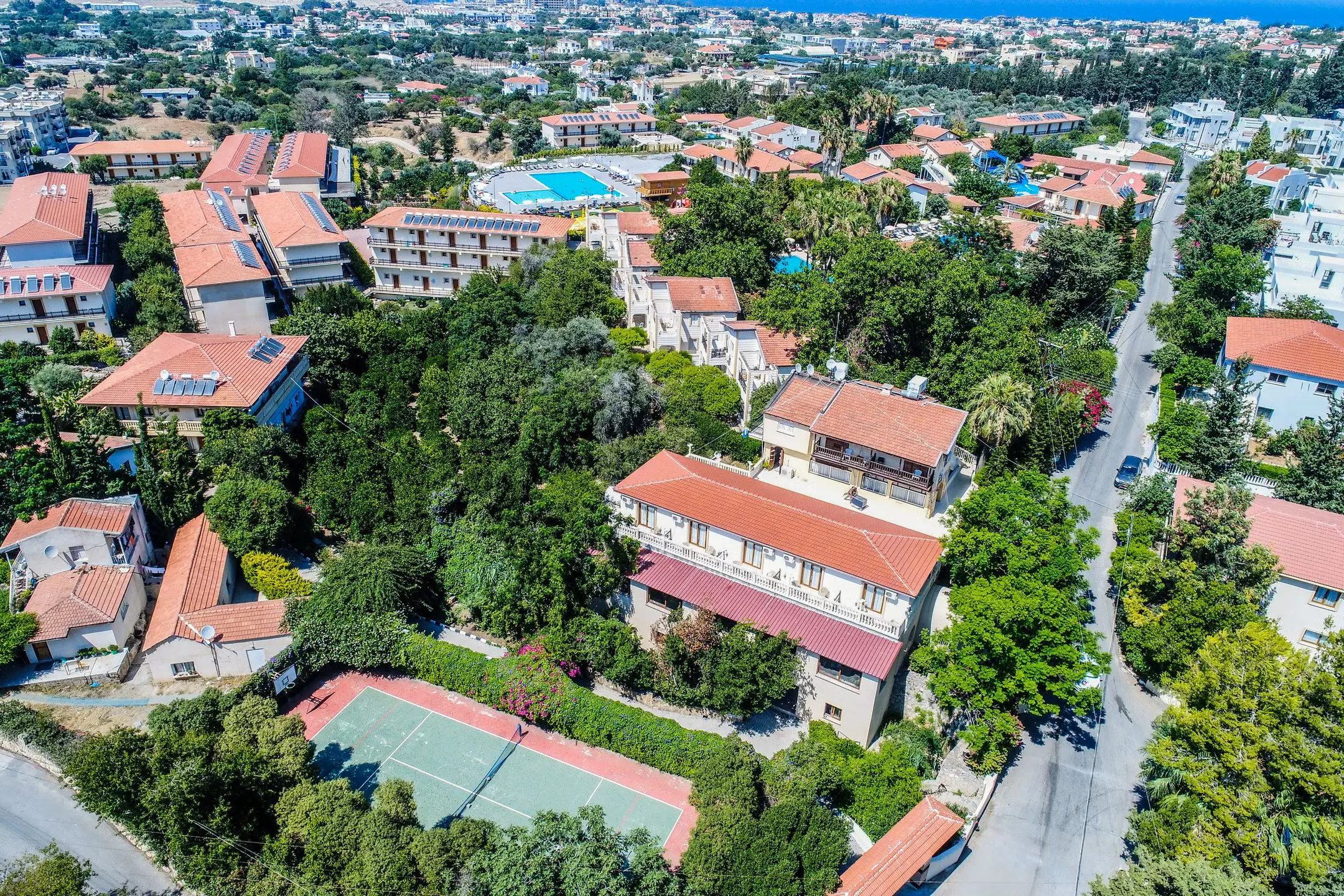 Private luxury taxi arriving at Riverside Garden Resort in Kyrenia, North Cyprus, surrounded by lush greenery and mountain backdrop